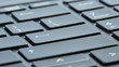 Gray laptop keyboard close-up. Selective focus on enter buttons.