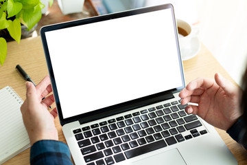 mockup image blank screen computer with white background for advertising text,hand man using laptop contact business search information on desk at home office.marketing and creative design