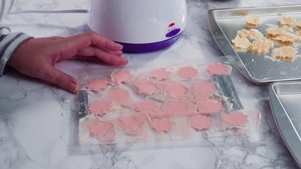 Sticker - Step by step. Pouring melted chocolate into a plastic chocolate mold in the shape of snowflakes.