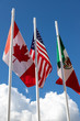 Flags of United States, Mexico, Canada fluttering in the sky