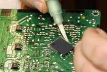Digital Electronics Repair, Applying Flux Solder From A Syringe To The Processor Contacts For Replacement