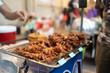 Fried pork in street food market in Bangkok, Thailand.
