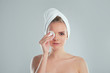 © yavdat - Healthy fresh girl removing makeup from her face with cotton pad. woman with a sponge wihte background cotton pad problem skin