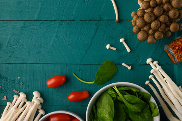 Wall Mural - Cooking salads with fresh ingredients for cooking. Space on a green wooden background. Fresh vegetables