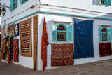 Fototapeta  - Moroccan  carpets in the street shop souk of Asilah, Morocco