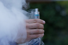 Hand Holding Atomiser Or Electronic Cigarette With Vapour Smoke