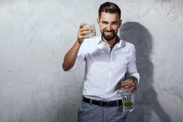 Wall Mural - Handsome bearded man with a glass of whiskey