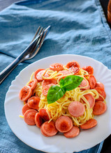 Pasta Spaghetti With Fried Sausage In White Plate On Table