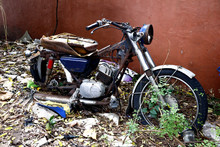 Old, Broken And Rusty Motorcycle At An Empty Lot