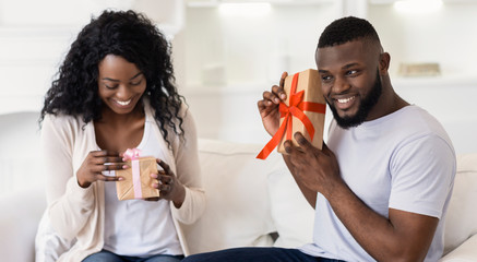 Sticker - Happy african american couple exchanging gifts with each other