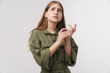 Photo of confused cute woman posing and counting her fingers