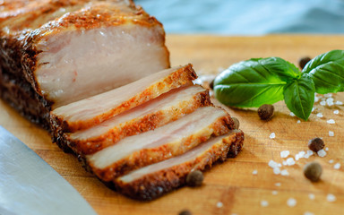 Poster - Close up view of a piece of roasted pork belly on wooden cutting board