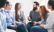 © Prostock-studio - Therapist talking with patients during support group session