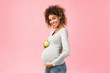 Healthy nutrition. Happy expectant woman holding apple
