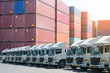 New haulage truck fleet is parking in the container depot as for shipping, logistics, business transportation background.