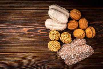 Wall Mural - Different types of cookies on dark wooden background.