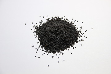 Wall Mural - pile of basil seeds tukmaria on white background