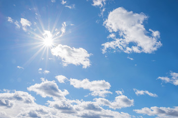 Wall Mural - cloud scape background with bright sun and fluffy cumulus