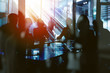 © alphaspirit - Background concept with business people silhouette at work. Double exposure and light effects