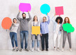 © Prostock-studio - Group of diverse friends holding blank colorful speech bubbles
