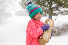 Lexi McKendry Helping Carry In Firewood On A Snowy Winter Day In Summit County, Colorado.