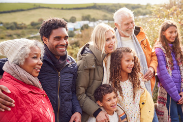 Wall Mural - Portrait Of Active Multi-Generation Family On Winter Beach Vacation Resting By Gate