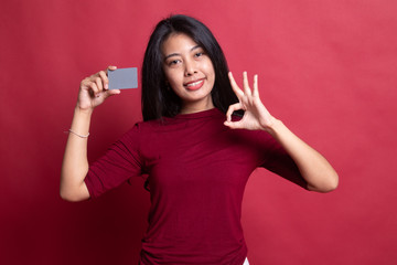 Wall Mural - Young Asian woman show OK with a blank card.