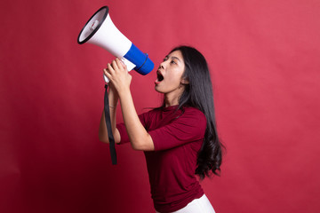 Wall Mural - Beautiful young Asian woman announce with megaphone.