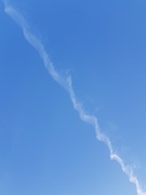 Inversion Trail Of An Airplane In The Blue Sky