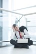 © MDBPIXS - Stressed out businessman seated on floor working at laptop