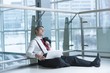 © moodboard - Businessman sitting on ground asleep with laptop