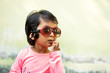 © Cavan Images - Cute little girl wearing sunglasses and making fun outdoors