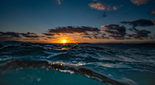 Orange Sunrise From The Water At Sandy's Beach In Oahu, Hawaii
