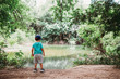 © Cavan Images - Young boy looking at water near Barton Springs