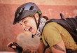 © Cavan Images - a female cyclist wearing a helmet laughs and smiles with joy