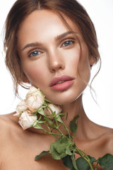 Wall Mural - beautiful woman with classic nude make-up, light hairstyle and flowers. beauty face.