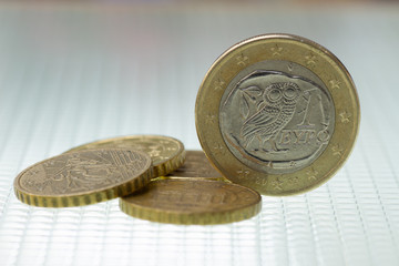 Euro coin with Greek 2 euro pieces on a light background