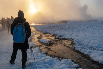 Wall Mural - Tourist at the snowy geysir geothermal area on the golden circle in Iceland