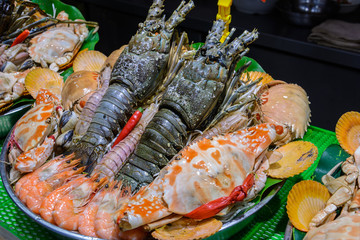 Chinese street food. Street trading. Chinese kinds of fresh seafood at an asian seafood market in Sanya, Hainan province, China. Inscription: name food.