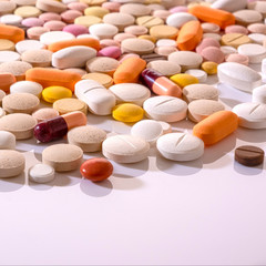 Lots of different multicolored medicinal medicine drugs, pills, tablets, capsules. Pharmacy theme background, closeup, concept