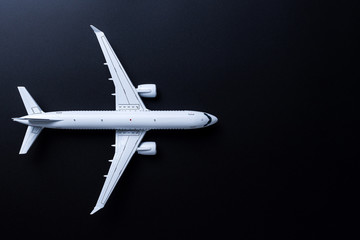 The passenger plane on black background with empty space for text. Top view, copy space