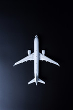 Travel Concept. Top View Of Jet Airliner On Black Background. Commercial Passenger Or Cargo Aircraft, Business Jet Ready For Flight