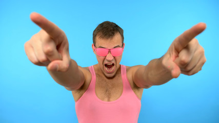 stylish guy in the pink glasses dancing on a blue background