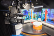 © sarawut - Camera in studio are broadcasting journalists reading news.Blur background have table for reporter.