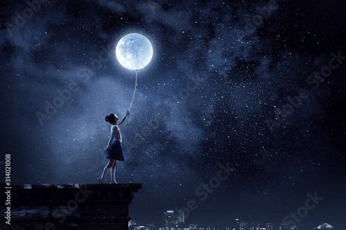 Photographie Kid girl catching moon. Mixed media
