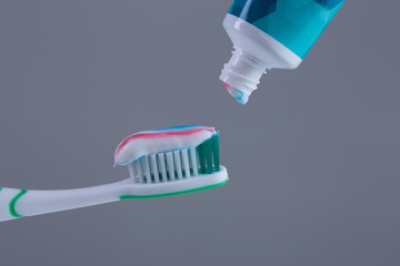 Toothbrush with colored toothpaste, care for the oral cavity and teeth, vector.