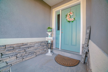 Wall Mural - Welcome signs alongside a green front door