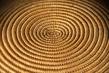 Background Of A Spiral Woven Wicker Texture - Detail Of A Brown And Orange Basket, Selective Focus