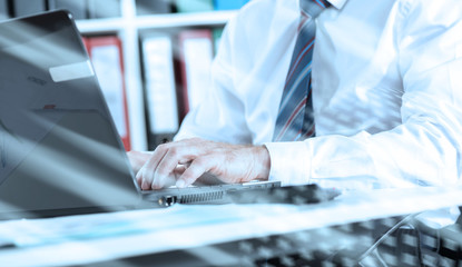 Businessman typing on laptop computer; light effect