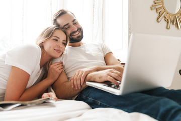 Poster - Beautiful young couple relaxing on bed